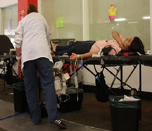 Jeanne Ricci takes Karen Plaza, 19, a nursing students blood donation.